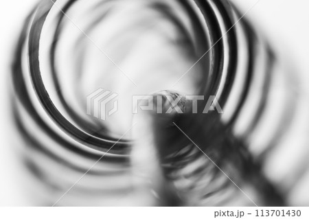 Metal spring coiled, black and white macro shot 113701430