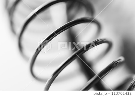 Metal spring coiled, black and white macro shot 113701432