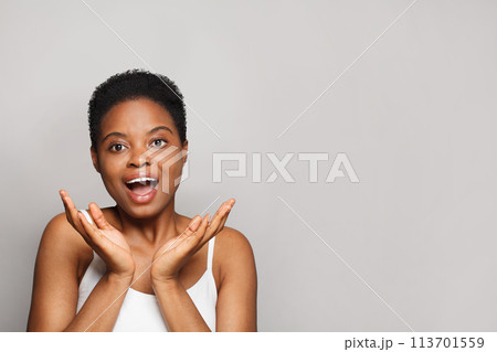 Surprised wellness model woman with dark shiny skin and cute smile close-up portrait. Surprised wellness model woman with dark shiny skin and cute smile close-up portrait. 113701559