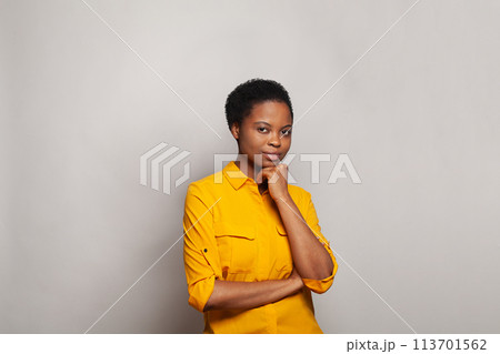 Young clever thinking African American woman standing on white background 113701562