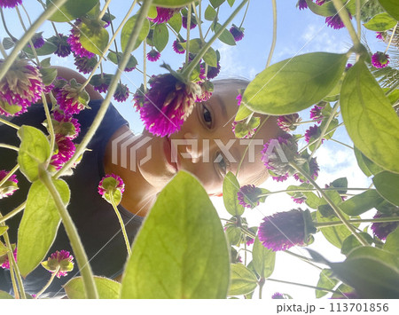 Cute child girl with flower against sky, summer portrait 113701856