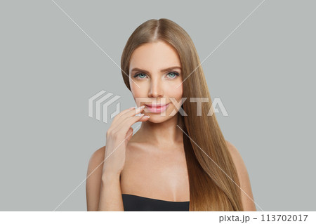Cute fashion model woman with long healthy hairstyle, fresh shiny skin and makeup 113702017