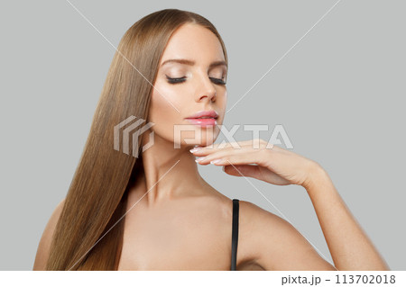 Young adult glamorous woman fashion model with long straight healthy hair and makeup posing Young adult glamorous woman fashion model with long straight healthy hair and makeup posing 113702018