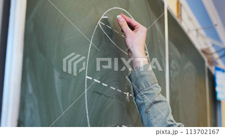 Guy draws figures on the board. Geometry class. 113702167