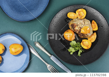 Baked pork meat with medlar. 113702398