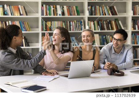 Happy students giving high five celebrate good teamwork results 113702639