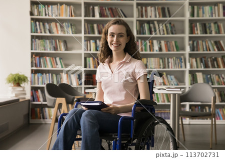 Girl with mobility disability sit in wheelchair in library 113702731
