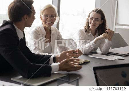 Mature and young teammates met in boardroom for briefing event 113703160