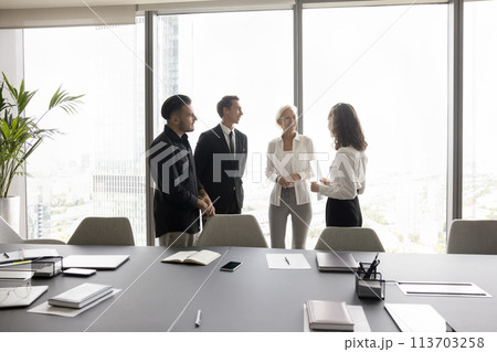Businesspeople engaged in friendly business communication before or after negotiations Businesspeople engaged in friendly business communication before or after negotiations 113703258