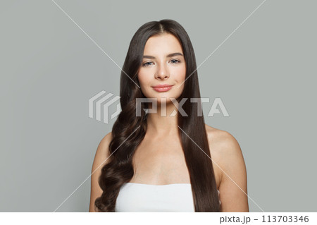 Charming young woman with long brown hair. Hair styling concept 113703346