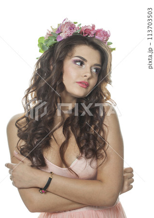 Isolated young model with long curly hair, makeup and perfect healthy skin, floral blossom portrait. Isolated young model with long curly hair, makeup and perfect healthy skin, floral blossom portrait. 113703503