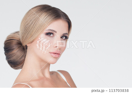 Blonde fashion model face close up. Medicine, facial treatment, massage and plastic surgery concept Blonde fashion model face close up. Medicine, facial treatment, massage and plastic surgery concept 113703838