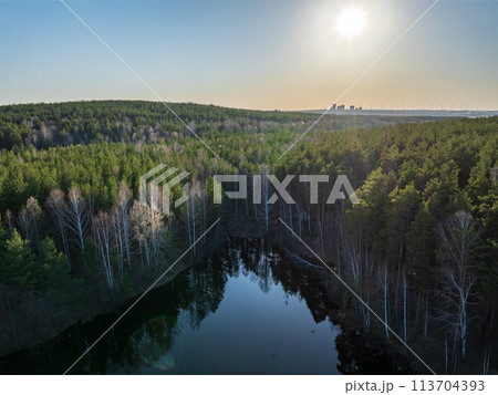 Spring or autumn lake in forest. Aerial view of lake in spring or autumn 113704393