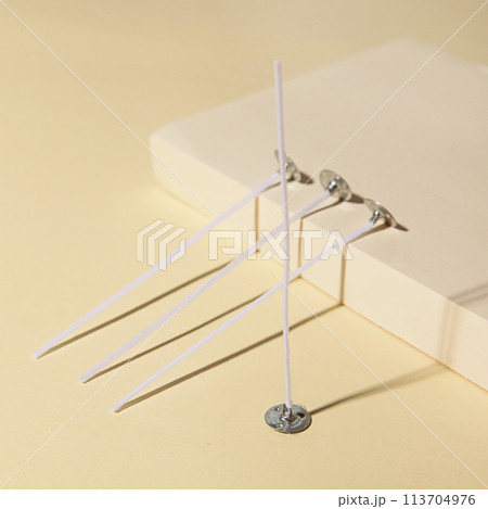 Candle Wicks on Beige background. Making homemade candle 113704976