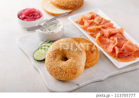Freshly baked bagels served with dill cream cheese and salmon Freshly baked bagels served with dill cream cheese and salmon 113705777