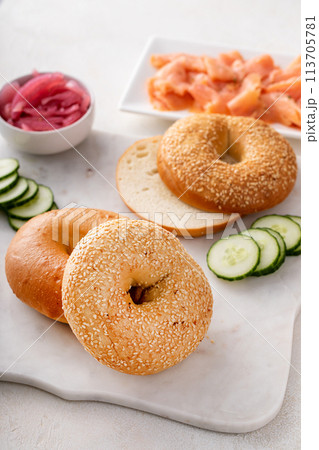Freshly baked bagels served with dill cream cheese and salmon Freshly baked bagels served with dill cream cheese and salmon 113705781