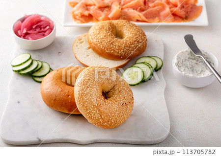 Freshly baked bagels served with dill cream cheese and salmon 113705782
