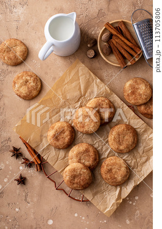Cinnamon cookies on a parchment paper with milk Cinnamon cookies on a parchment paper with milk 113705806