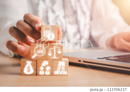Accounting concept, Businesswoman hand holding wooden block on desk with audit, analysis, balance, budget, calculation and advice icon on virtual screen. 113706237