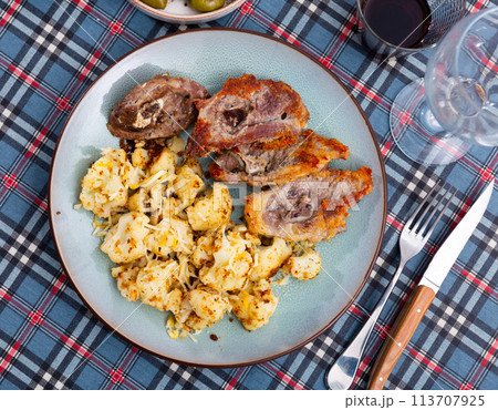 Fried fatty and juicy lamb and vegetable side dish of cauliflower with wine and olives Fried fatty and juicy lamb and vegetable side dish of cauliflower with wine and olives 113707925