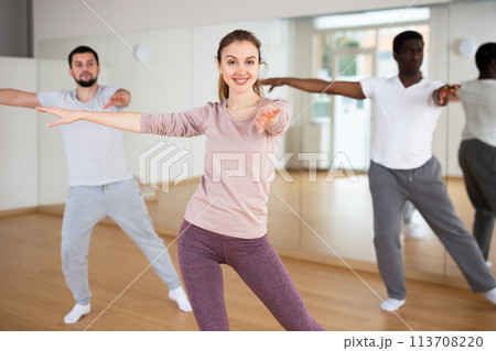 Woman and men dancing in fitness studio 113708220