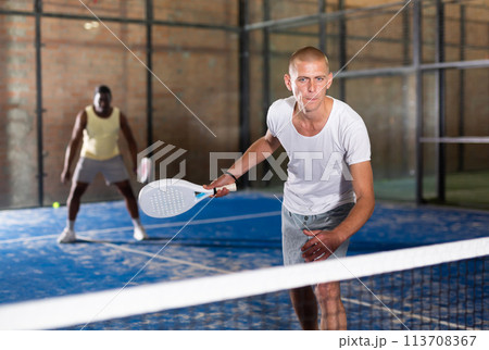 Padel tennis couple in court ready for play 113708367
