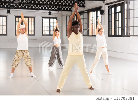 Portrait of smiling young dancing people practicing vigorous swing in studio Portrait of smiling young dancing people practicing vigorous swing in studio 113708381
