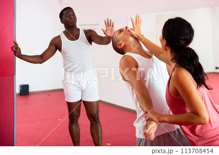 Man and woman performing chin strike during self-protection training Man and woman performing chin strike during self-protection training 113708454
