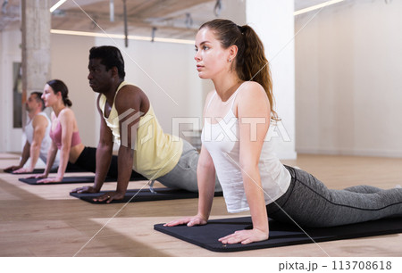 Young woman exercising during group pilates class 113708618