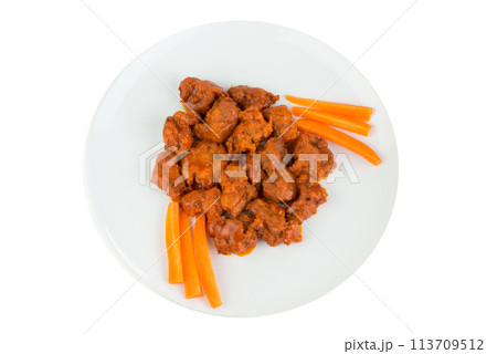Boneless chicken wings with buffalo sauce and carrots 113709512
