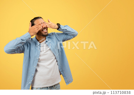 Man with covered face holding head in disbelief 113710838