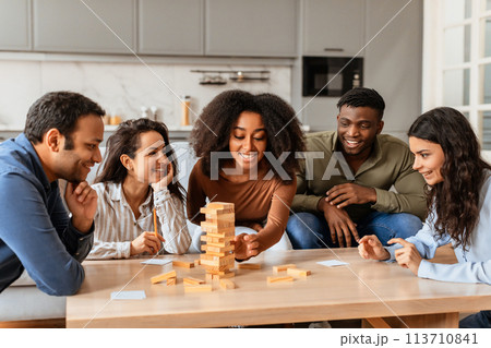 Young friends playing a block-stacking game at home 113710841