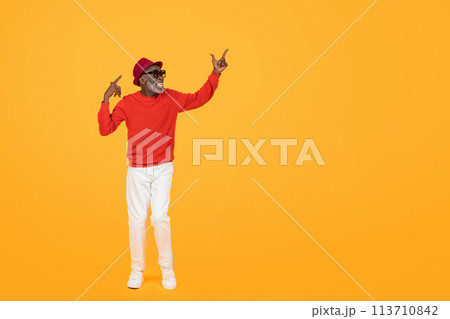 Stylish senior black man in a red sweater and hat, with sunglasses on Stylish senior black man in a red sweater and hat, with sunglasses on 113710842