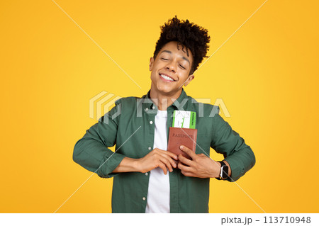 Content african american guy clutching passport and dreaming Content african american guy clutching passport and dreaming 113710948