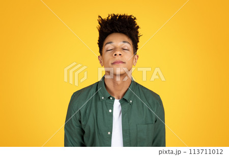 Young black man with closed eyes, peaceful 113711012