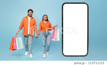Couple with shopping bags and giant smartphone Couple with shopping bags and giant smartphone 113711125