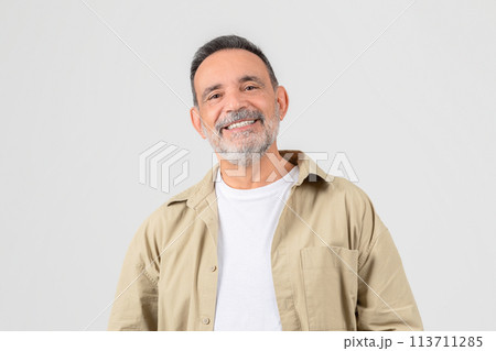 Senior smiling with hands in pockets on white background Senior smiling with hands in pockets on white background 113711285