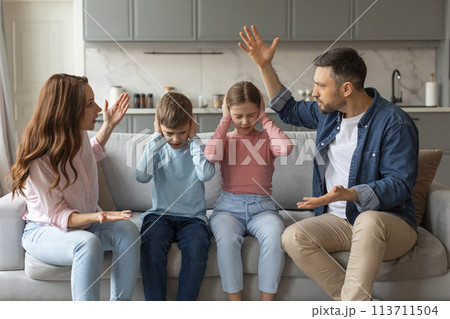 Domestic Quarrels. Man And Woman Arguing In Front Of Kids At Home 113711504