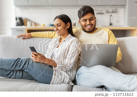 Content Indian couple using tech at home Content Indian couple using tech at home 113711622