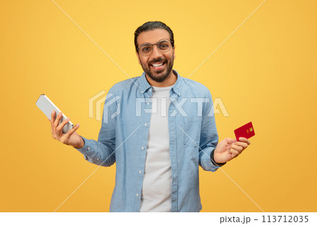Man with smartphone and credit card 113712035