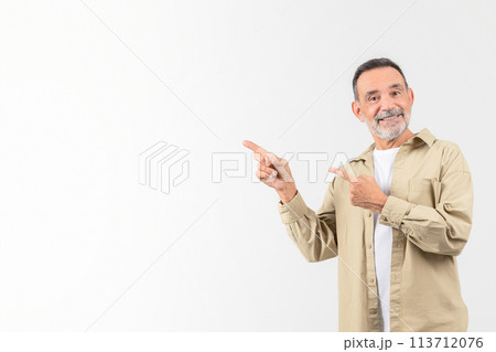 Senior man pointing to his side with a smile Senior man pointing to his side with a smile 113712076