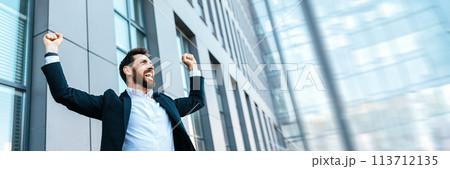 Happy satisfied businessman rejoices in successful deal or win 113712135