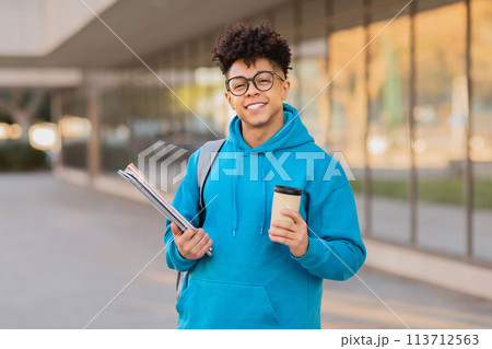 Happy student with coffee and books, copy space 113712563