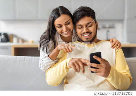 Indian Man and Woman Looking at Cell Phone 113712709