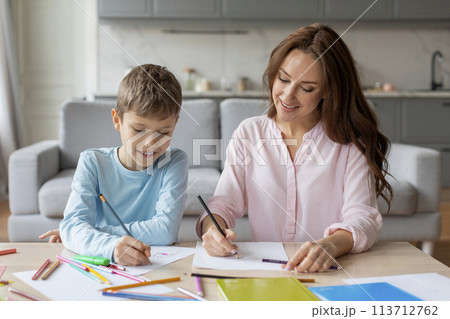 Mother and son drawing together at home Mother and son drawing together at home 113712762