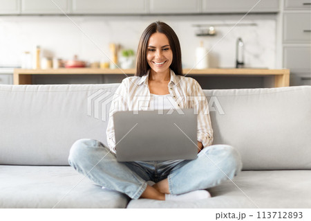 Happy woman using laptop at home, websurfing Happy woman using laptop at home, websurfing 113712893