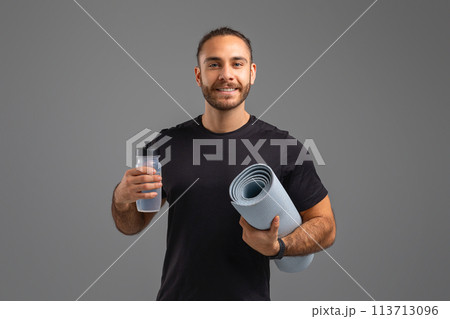 Man with yoga mat and water bottle Man with yoga mat and water bottle 113713096