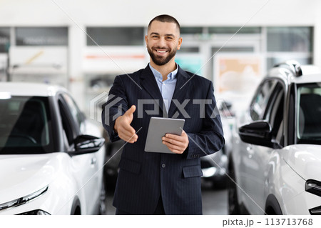 Confident car salesman with a digital tablet 113713768