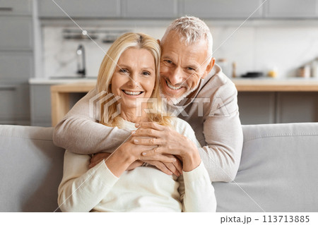 Mature couple smiling and hugging tightly 113713885
