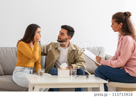 Couple at therapy session with counselor at clinic 113713918